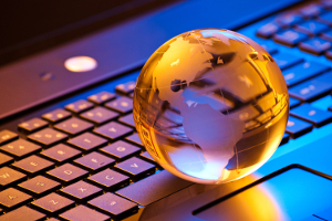 image of a globe paperweight on a computer keyword, used as a representational image for worldwide updates for the food industry